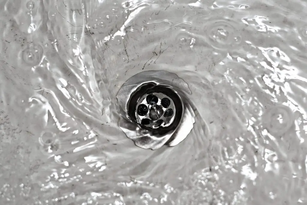 Water flowing into a clear sink drain